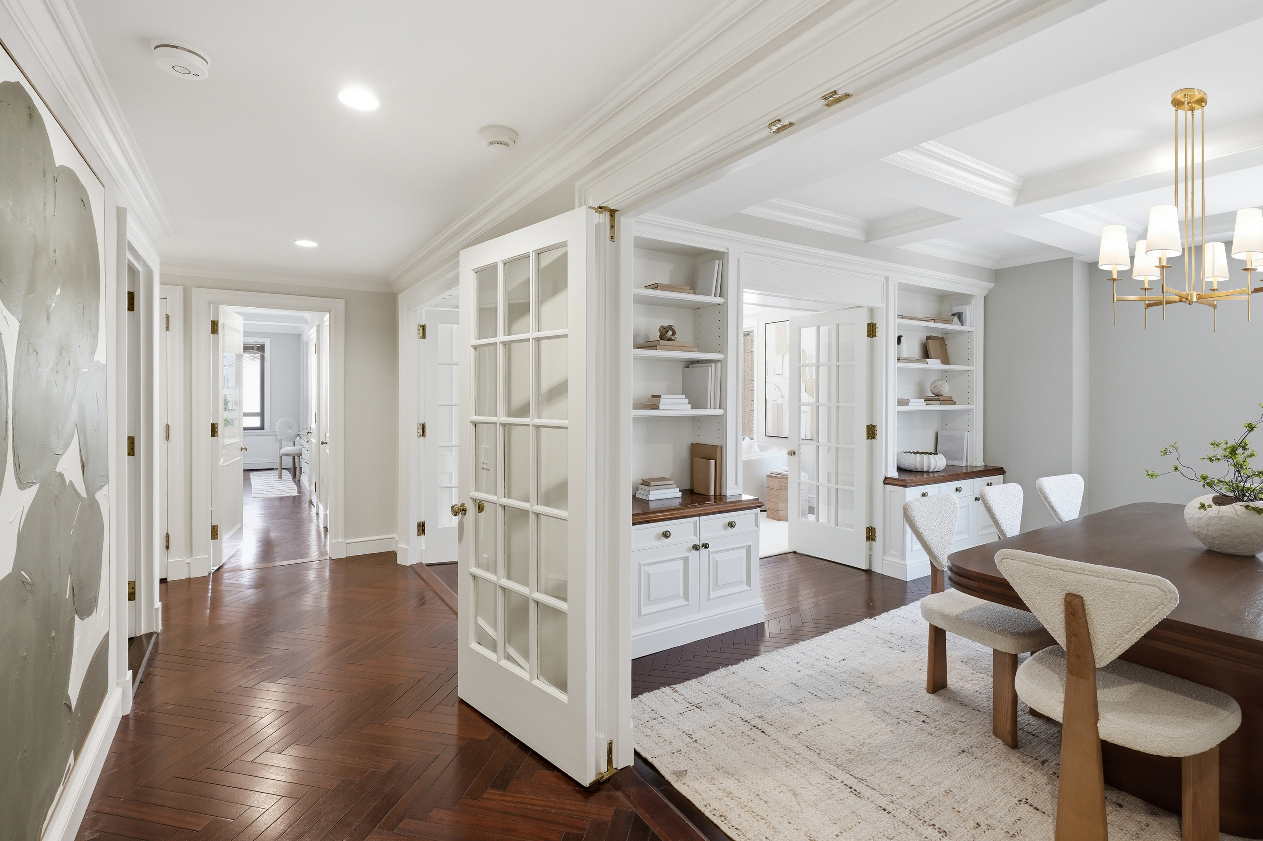 15 East 69th Street, Unit 7A Manhattan, NY 10021 - Photo 7 of 23 a living room with furniture wooden floor and a chandelier