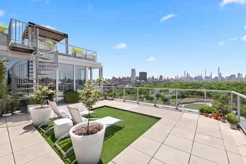 a view of a patio with couches and a table and chairs with potted plants