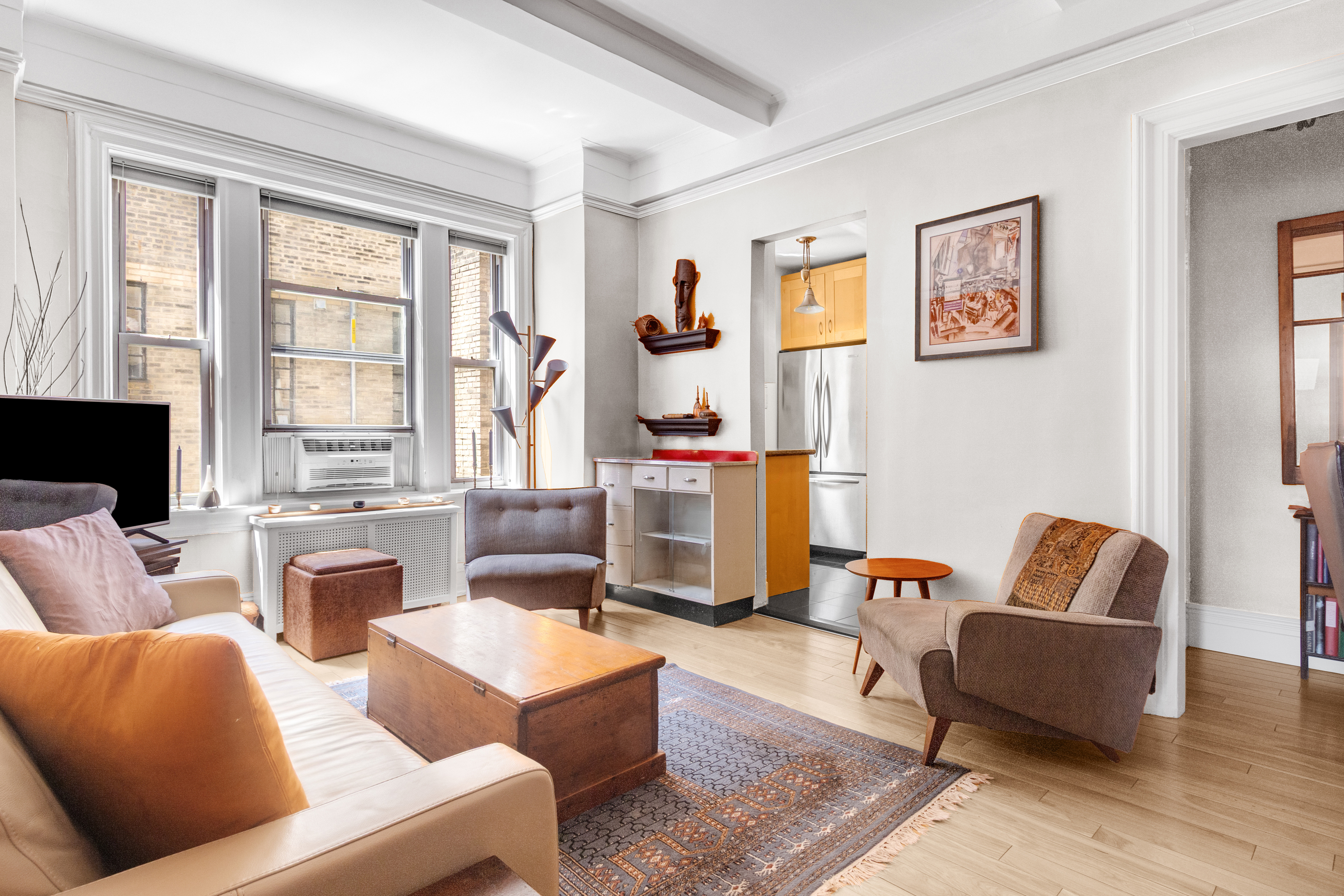588 West End Avenue, Unit 16D Manhattan, NY 10024 - Photo 2 of 12 a living room with fireplace furniture and a flat screen tv