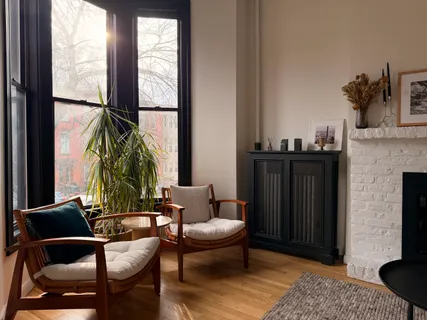a living room with furniture a window and a fireplace