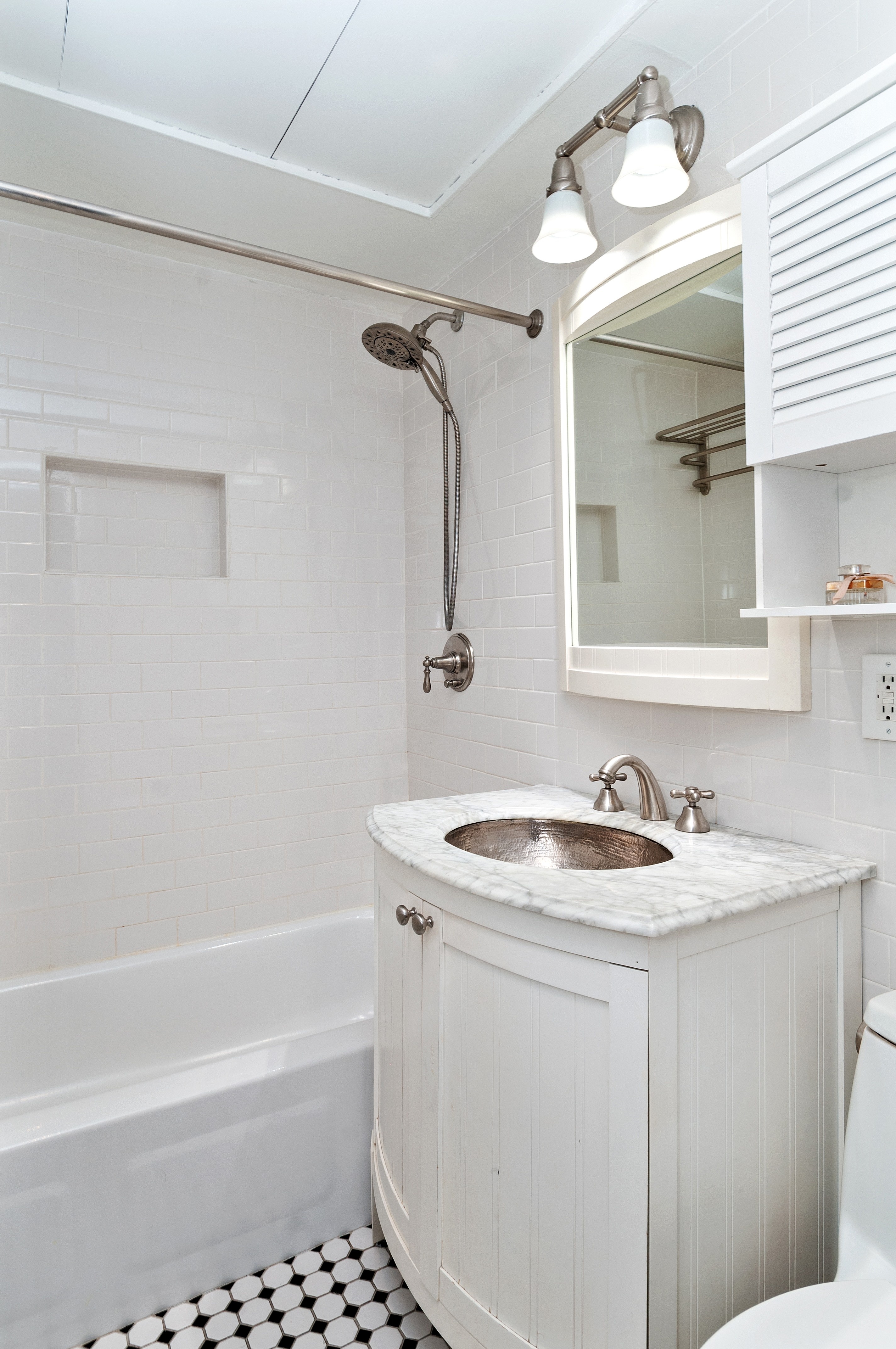 10 Christopher Street, Unit 4B Manhattan, NY 10014 - Photo 4 of 6 a bathroom with a sink a bath tub and a shower