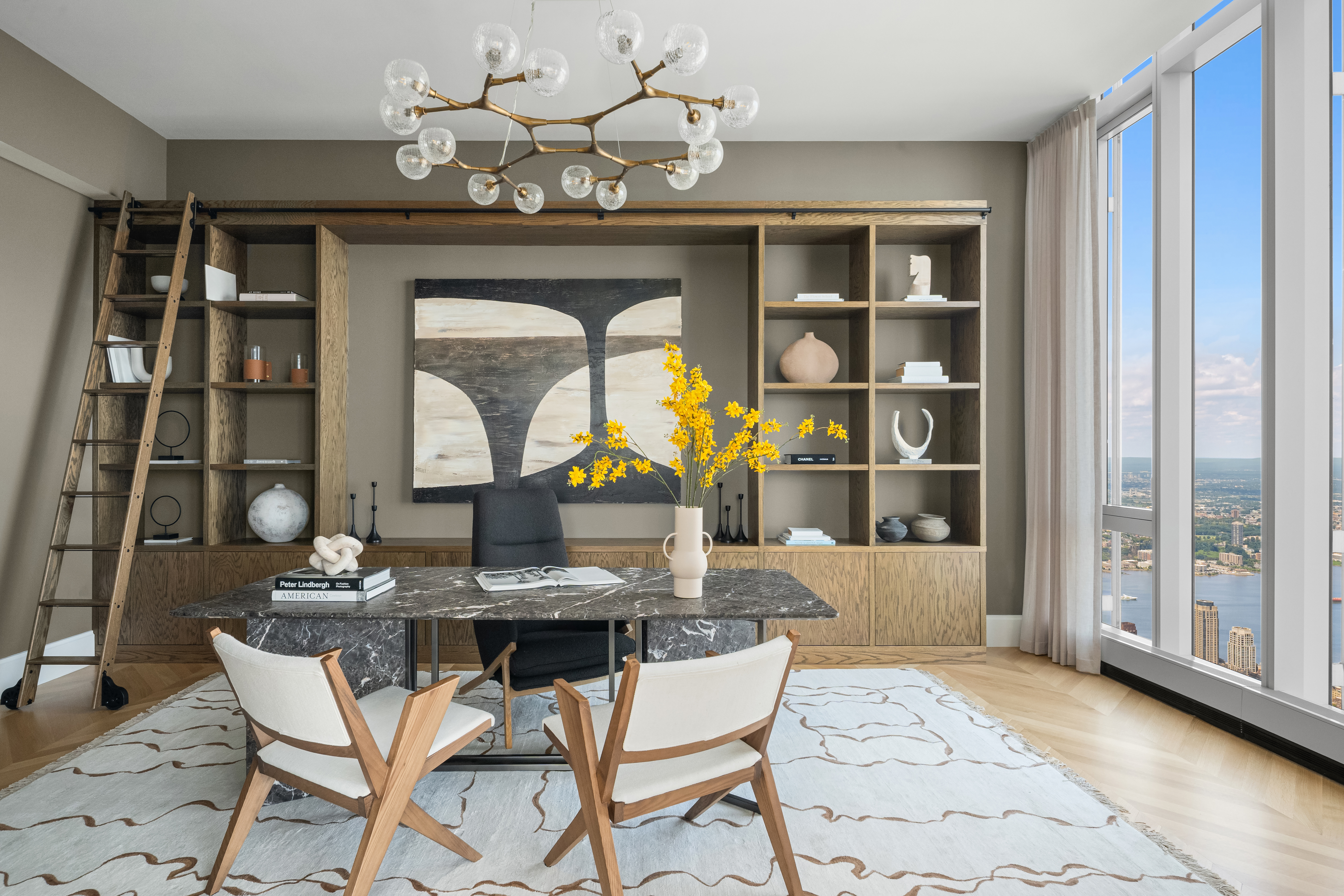 217 West 57th Street, Unit 127/128 Manhattan, NY 10019 - Photo 8 of 36 a view of a dining room with furniture and a chandelier