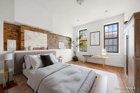a bedroom with a large bed and a large window