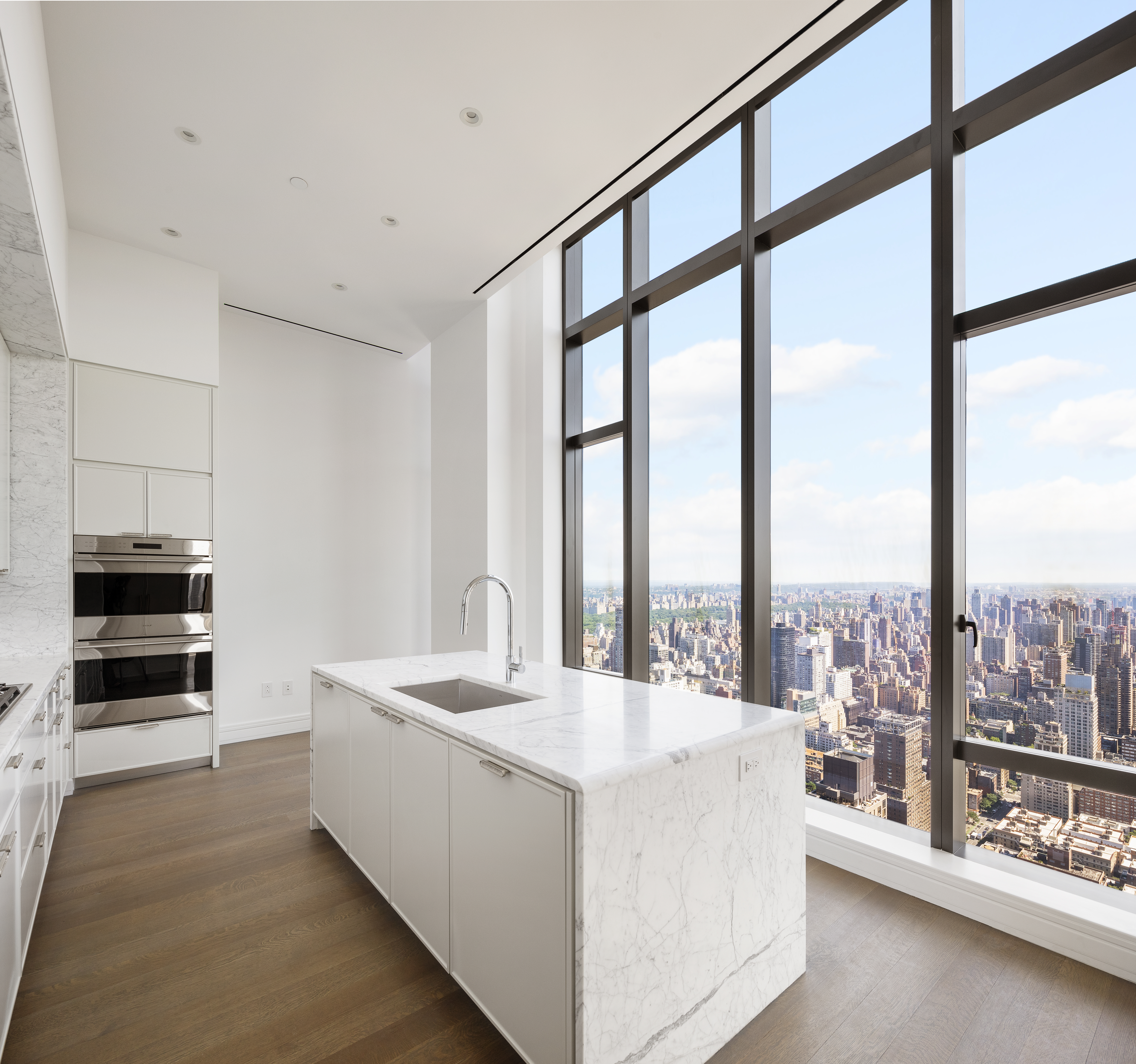 430 East 58th Street, Unit PH72 Manhattan, NY 10022 - Photo 5 of 26 a living room with a large window and furniture