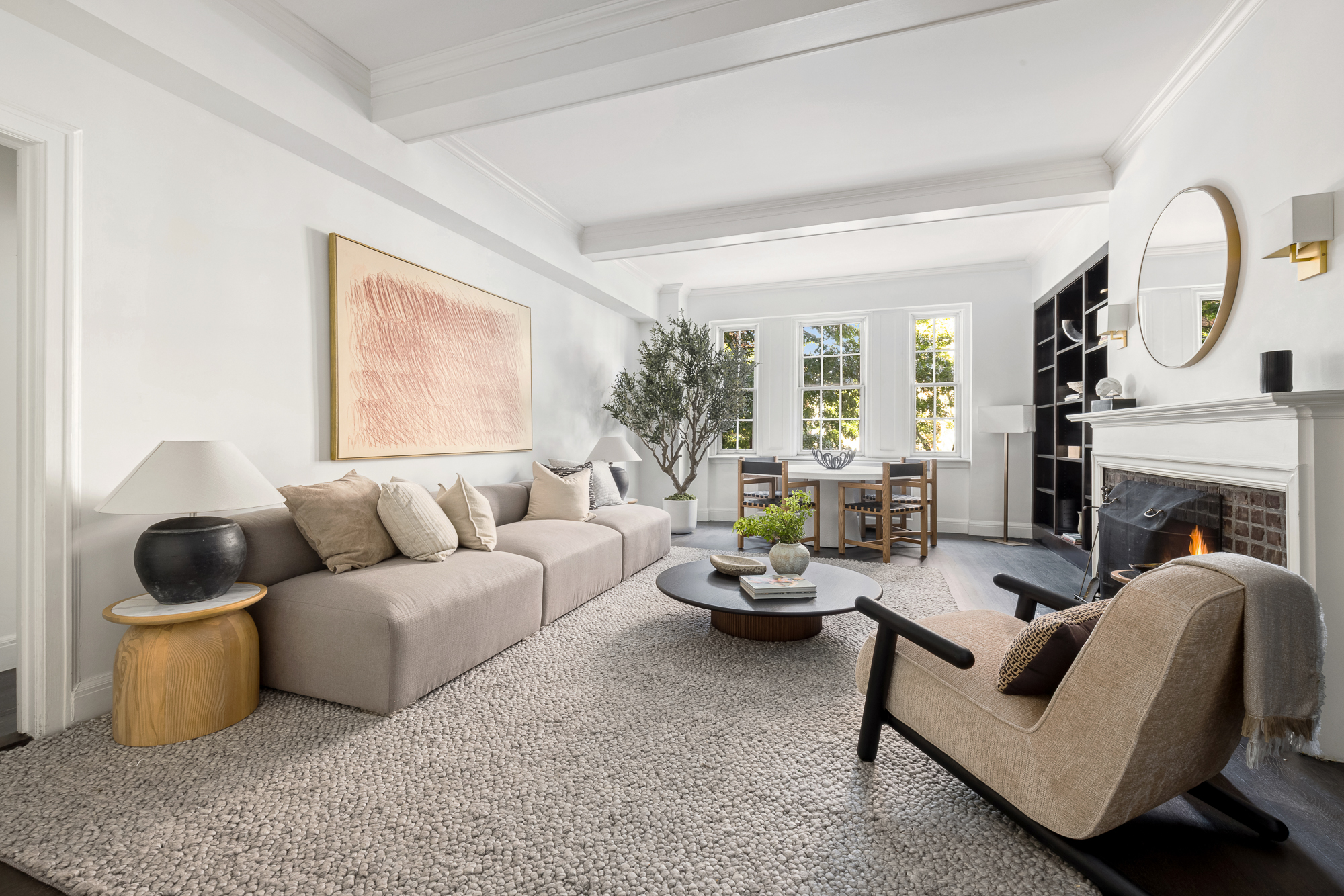 39 5th Avenue, Unit 2B Manhattan, NY 10003 - Photo 2 of 12 a living room with furniture a fireplace and a large window