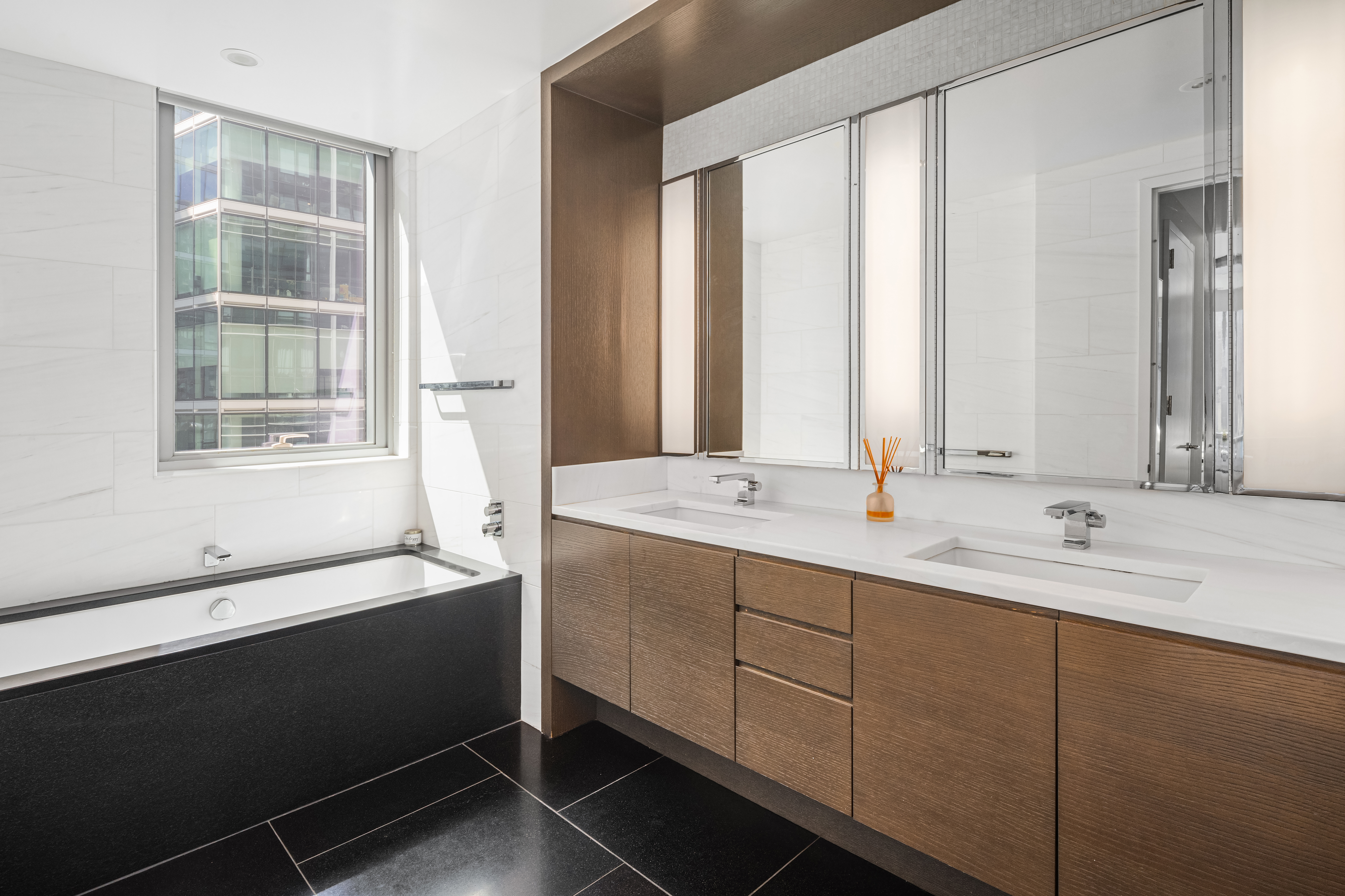 50 Riverside Boulevard, Unit 10P Manhattan, NY 10069 - Photo 9 of 21 a bathroom with a double vanity sink and a bathtub