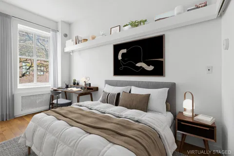 a bedroom with a bed and window