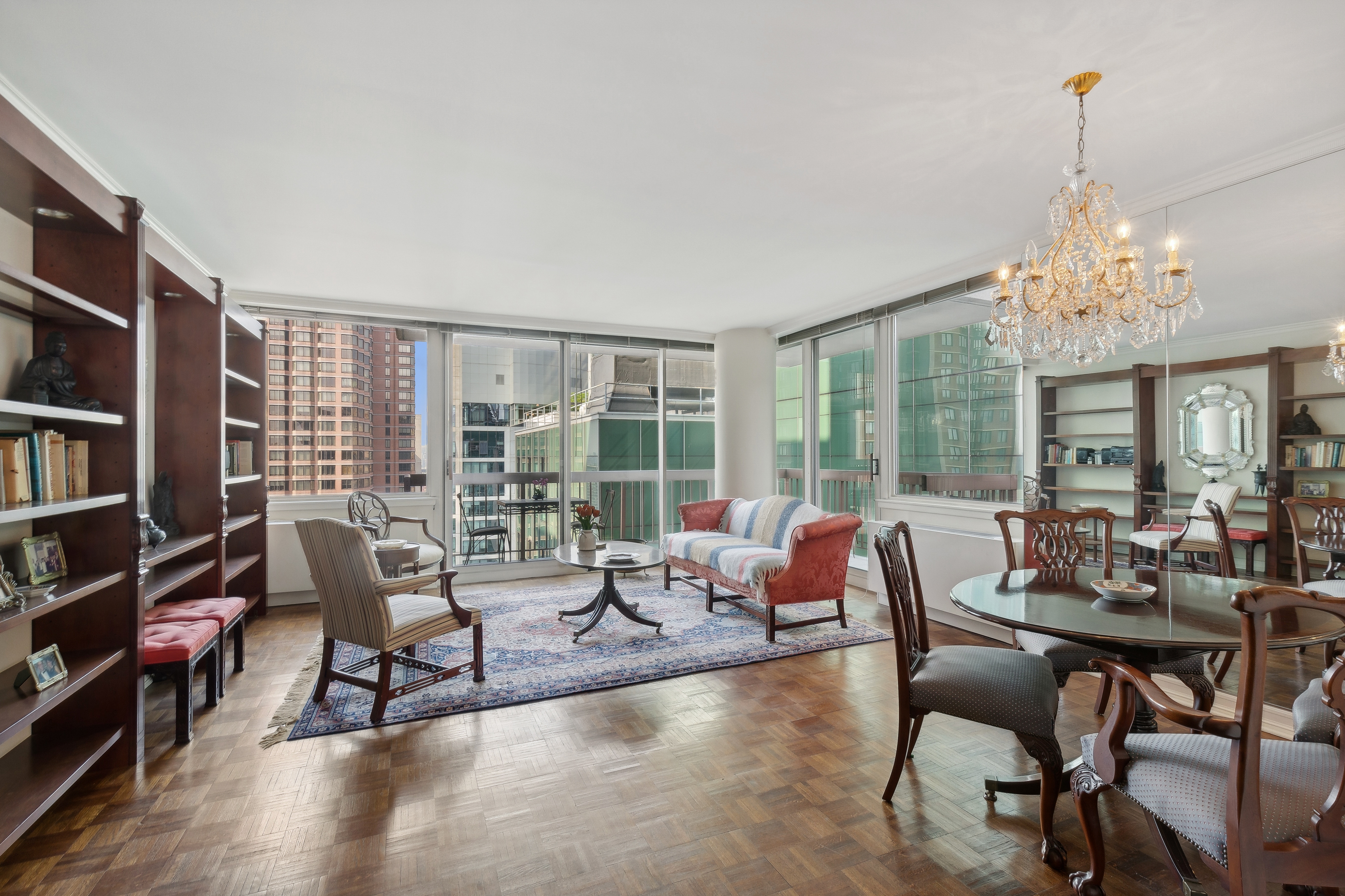 235 East 40th Street, Unit 37C Manhattan, NY 10016 - Photo 2 of 10 a living room with furniture and a chandelier