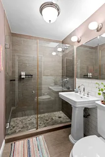 a bathroom with a sink toilet and shower