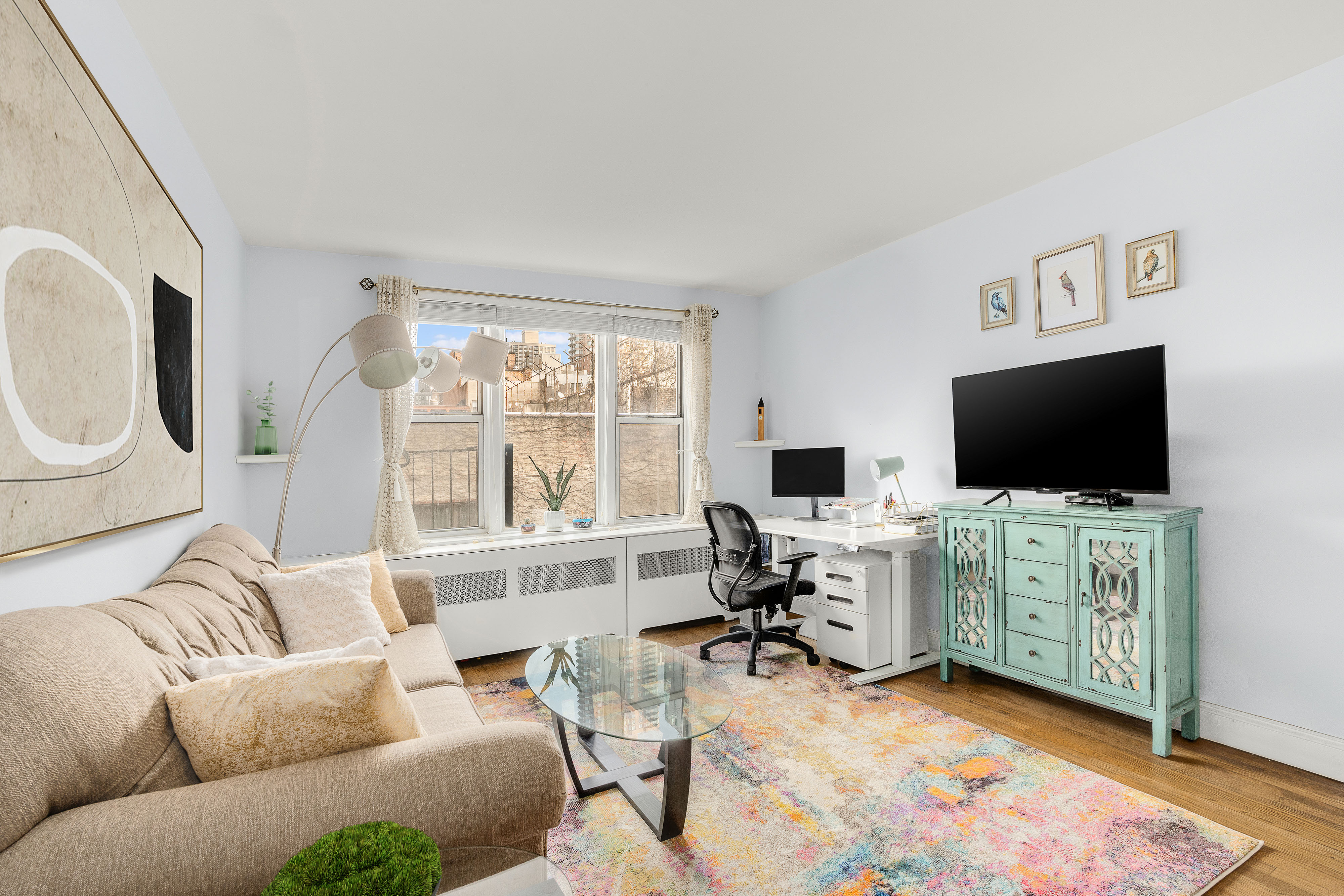 311 East 75th Street, Unit 4K Manhattan, NY 10021 - Photo 2 of 8 a living room with furniture and a flat screen tv