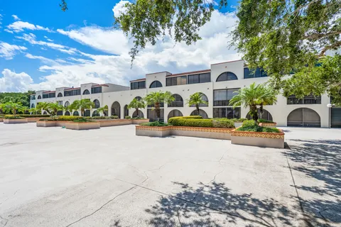 a view of a garden with flowers and trees