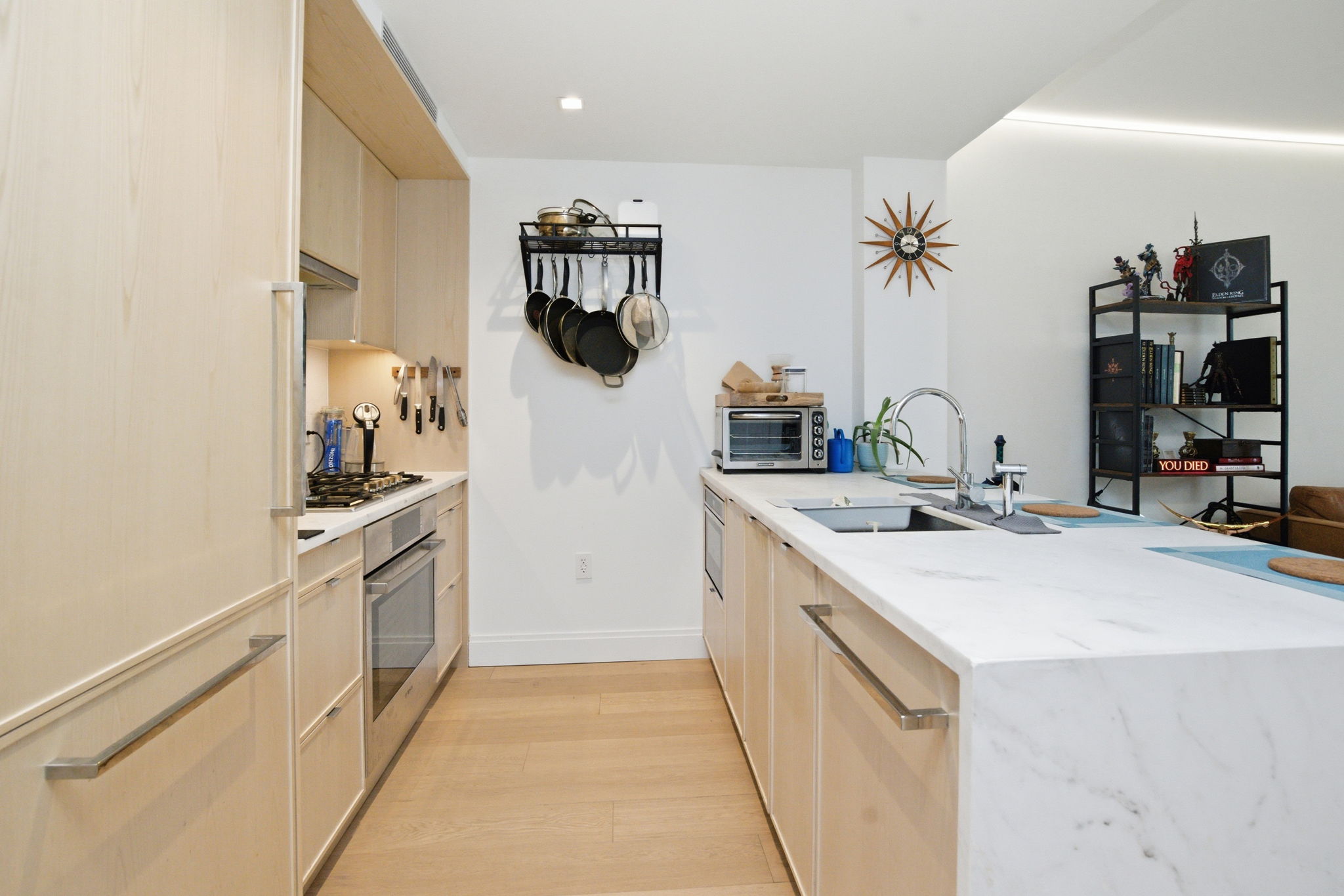 37-14 34th Street, Unit N3E Queens, NY 11101 - Photo 6 of 18 a kitchen with white cabinets and appliances