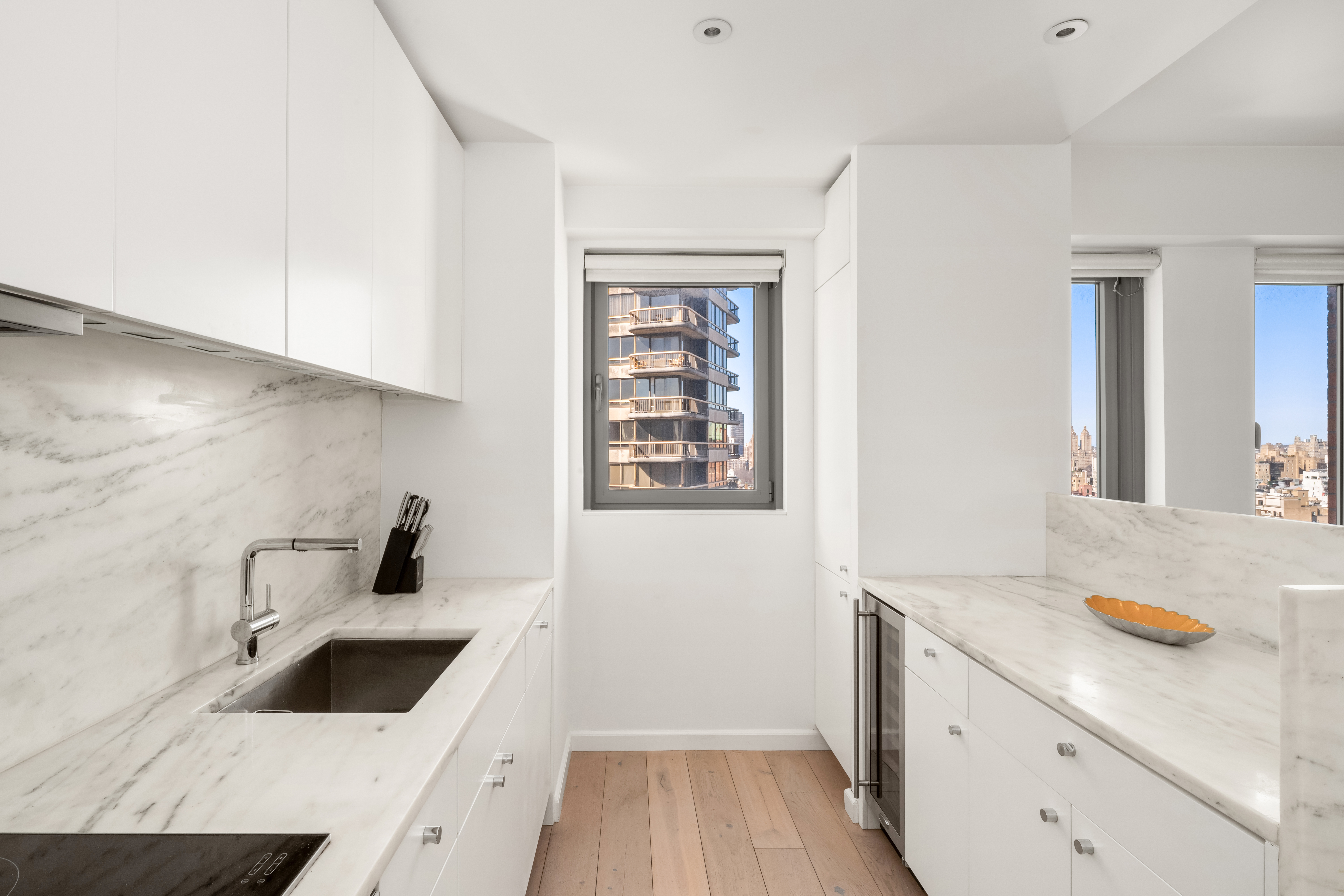 200 East 62nd Street, Unit 27A Manhattan, NY 10065 - Photo 5 of 19 a bathroom with a sink a vanity and window