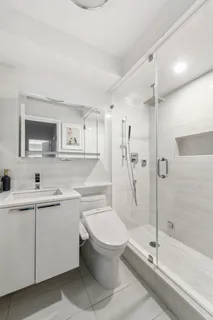 a bathroom with a shower a sink and mirror