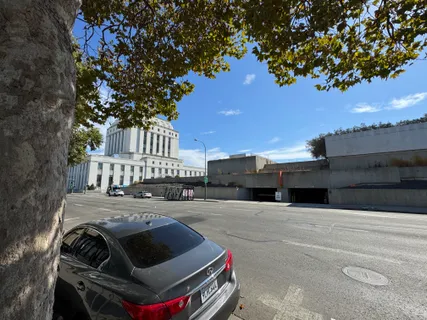 a roof deck with couches and wooden fence