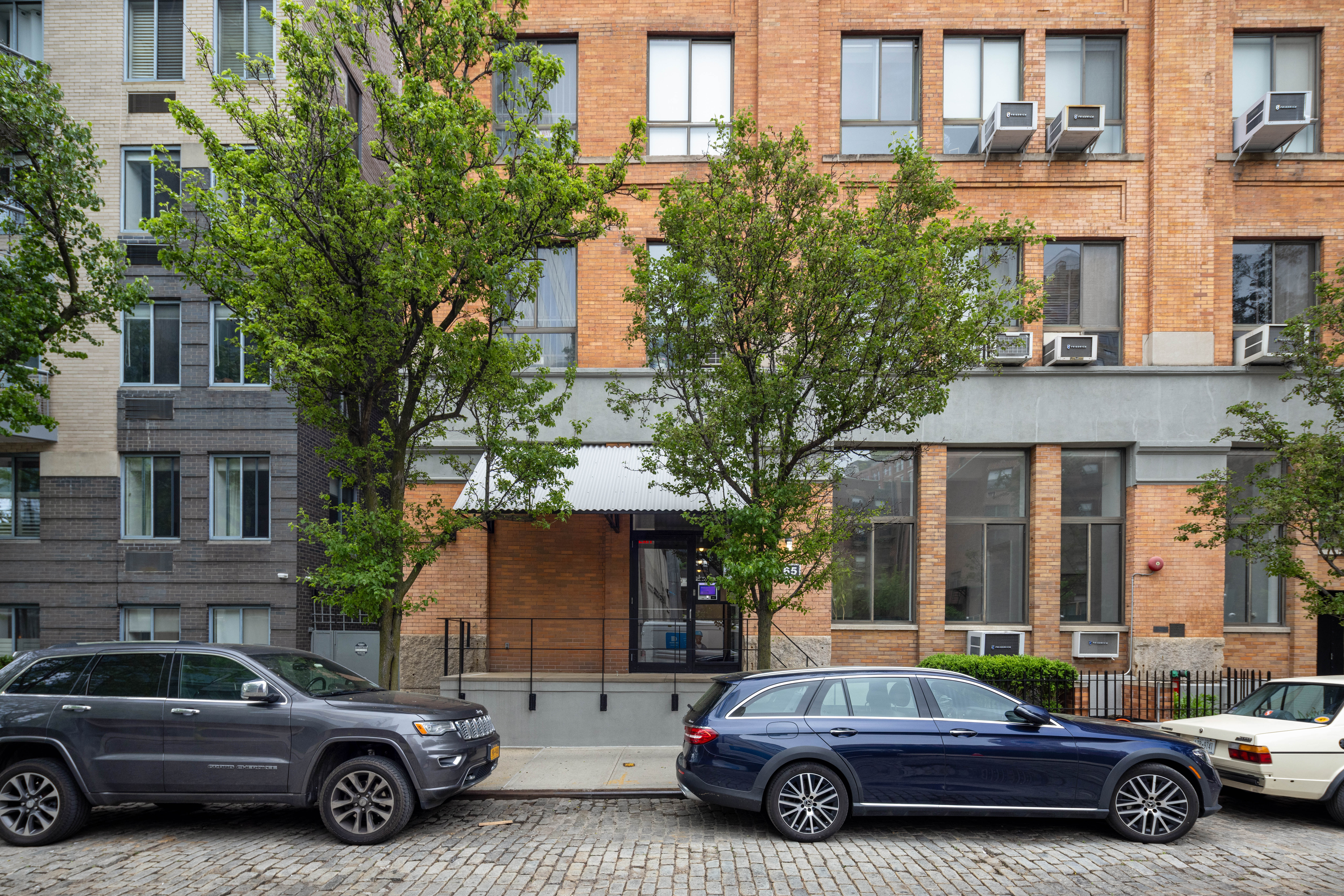 165 Perry Street, Unit 1D Manhattan, NY 10014 - Photo 12 of 13 a car parked in front of a house