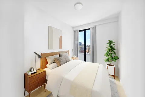 a bedroom with a bed and a potted plant