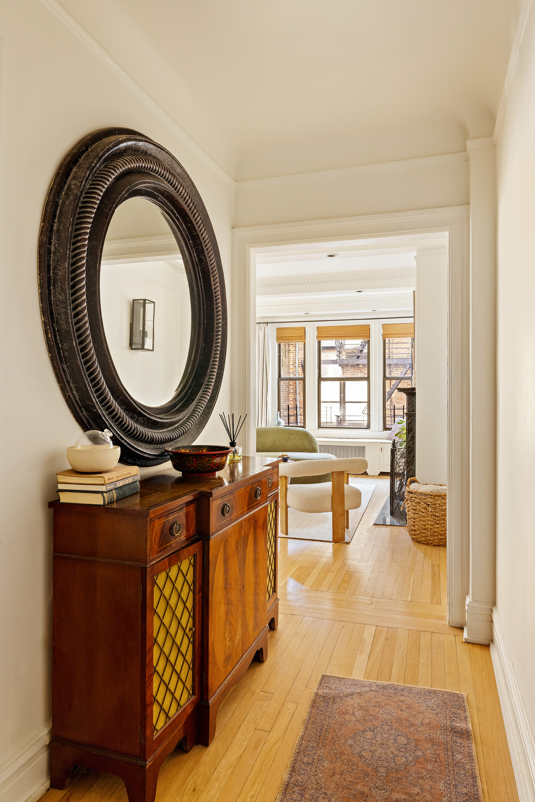 114 East 84th Street, Unit 3C Manhattan, NY 10028 - Photo 4 of 15 a living room with furniture a mirror a piano and a table