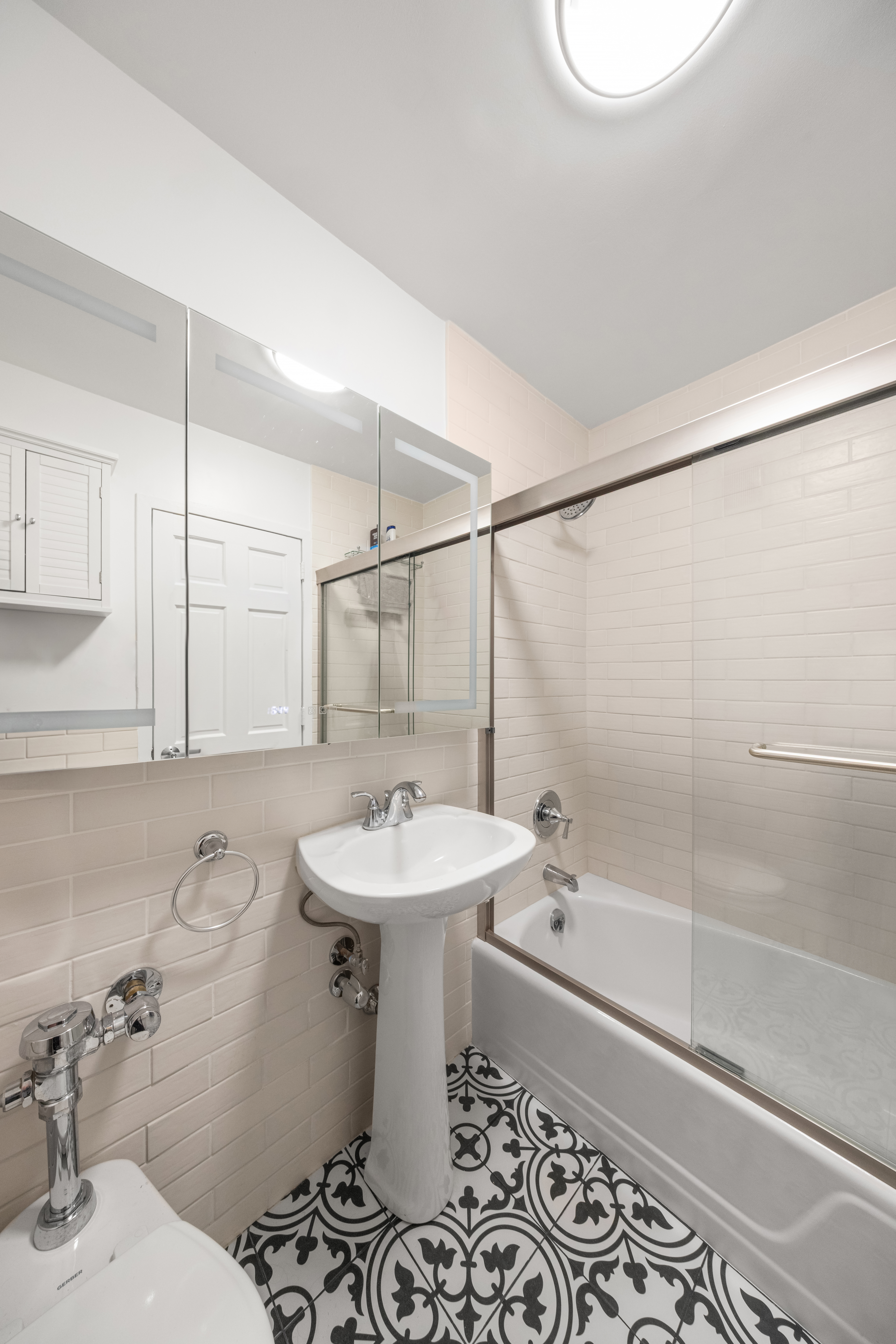 1160 3rd Avenue, Unit 6BC Manhattan, NY 10065 - Photo 12 of 13 a bathroom with a sink toilet and shower