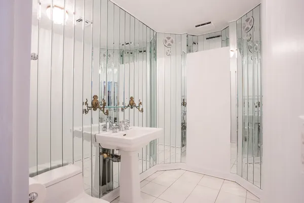 a bathroom with a sink a mirror and a shower