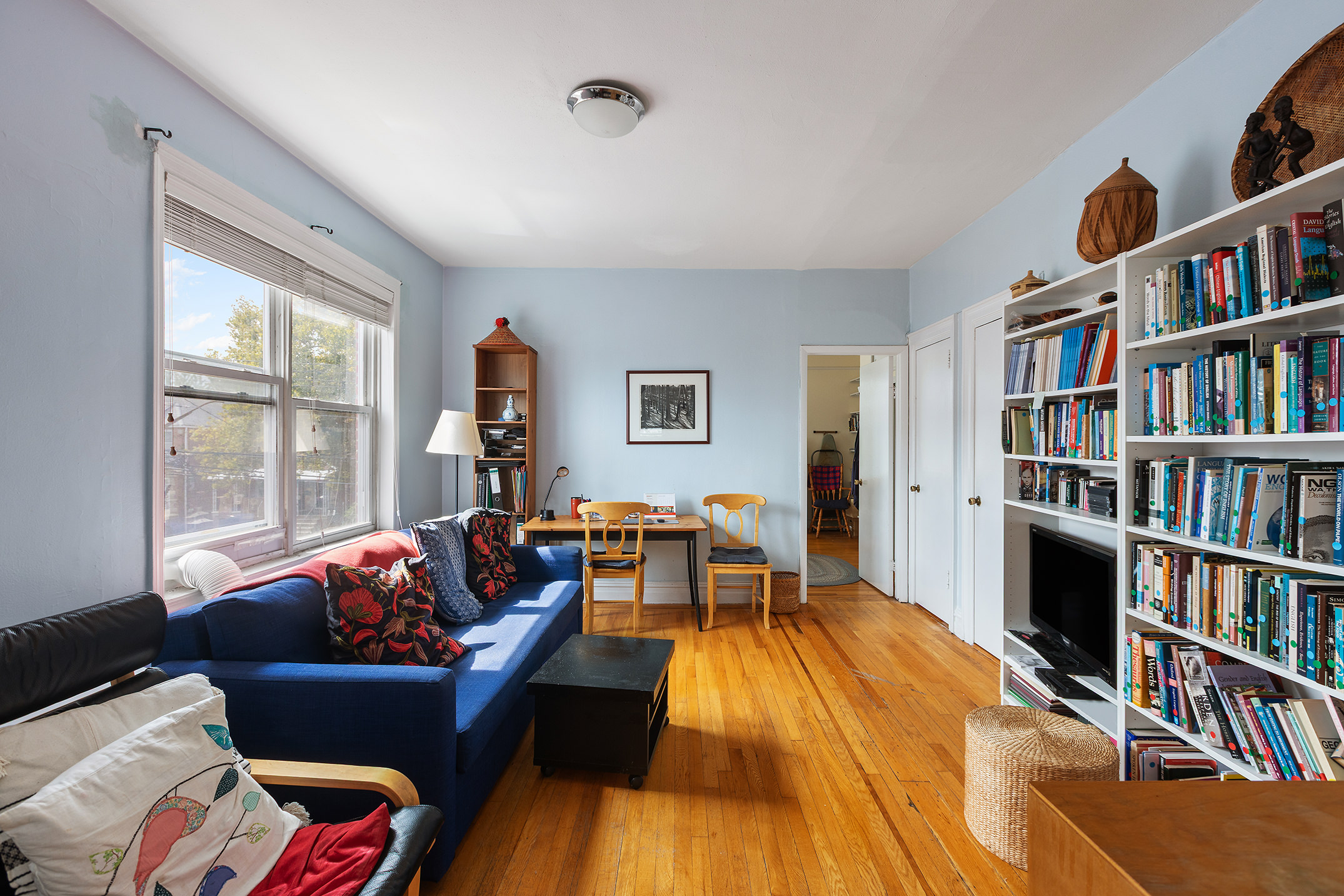 2536 Lurting Avenue Bronx, NY 10469 - Photo 12 of 27 a living room with furniture and a book shelf