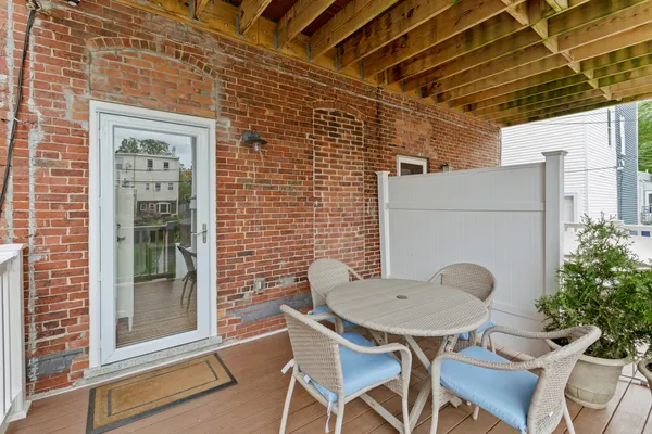 a backyard of a house with table and chairs