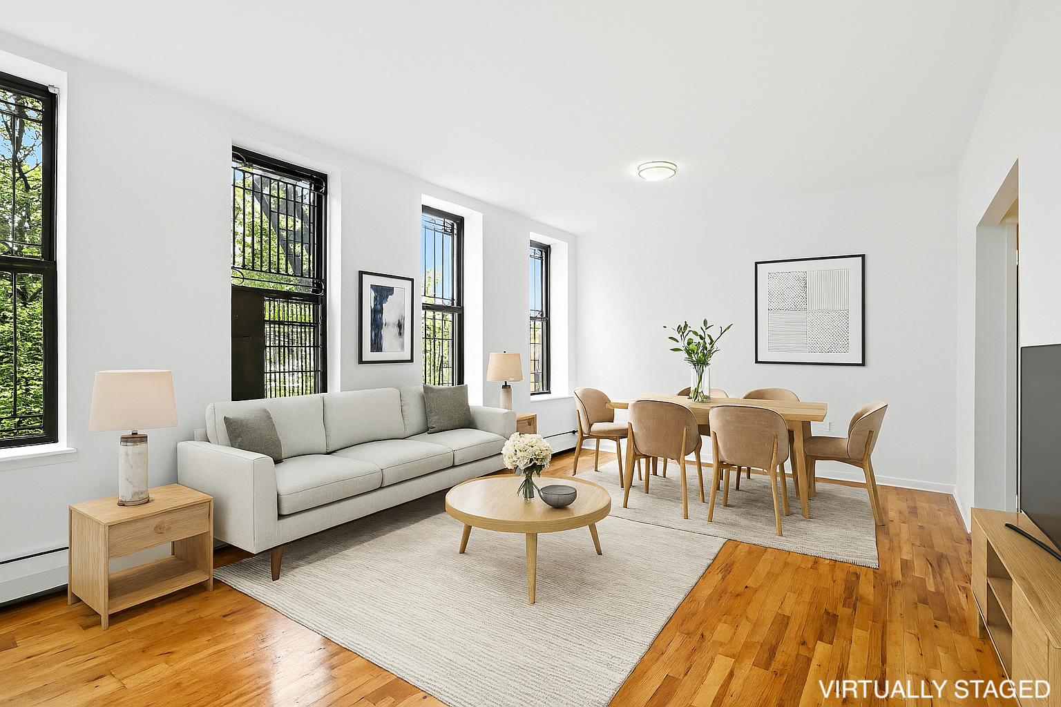 2611 Frederick Douglass Boulevard, Unit 4A Manhattan, NY 10030 - Photo 1 of 10 a living room with furniture wooden floor and a table