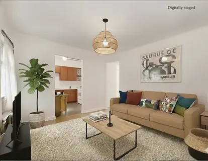 a living room with furniture plant and a large window