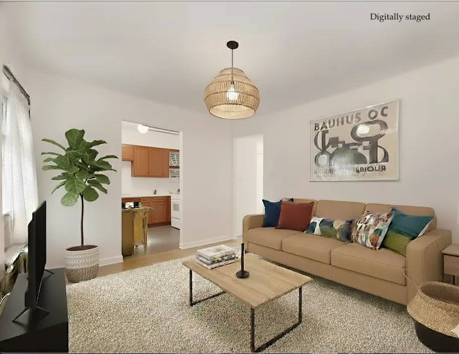 a living room with furniture plant and a large window