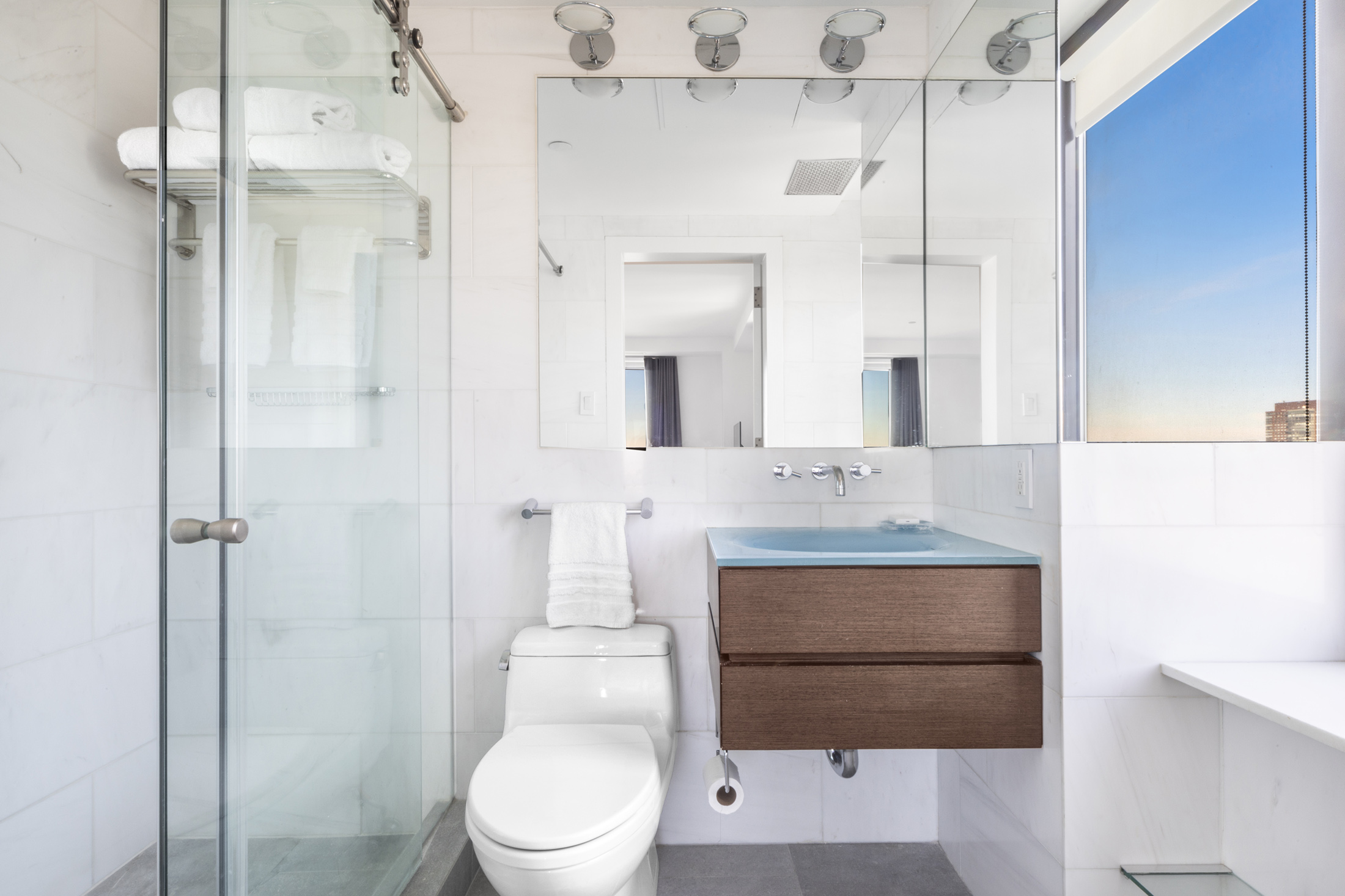 160 Central Park South, Unit 3903 Manhattan, NY 10019 - Photo 7 of 11 a bathroom with a sink a toilet and shower