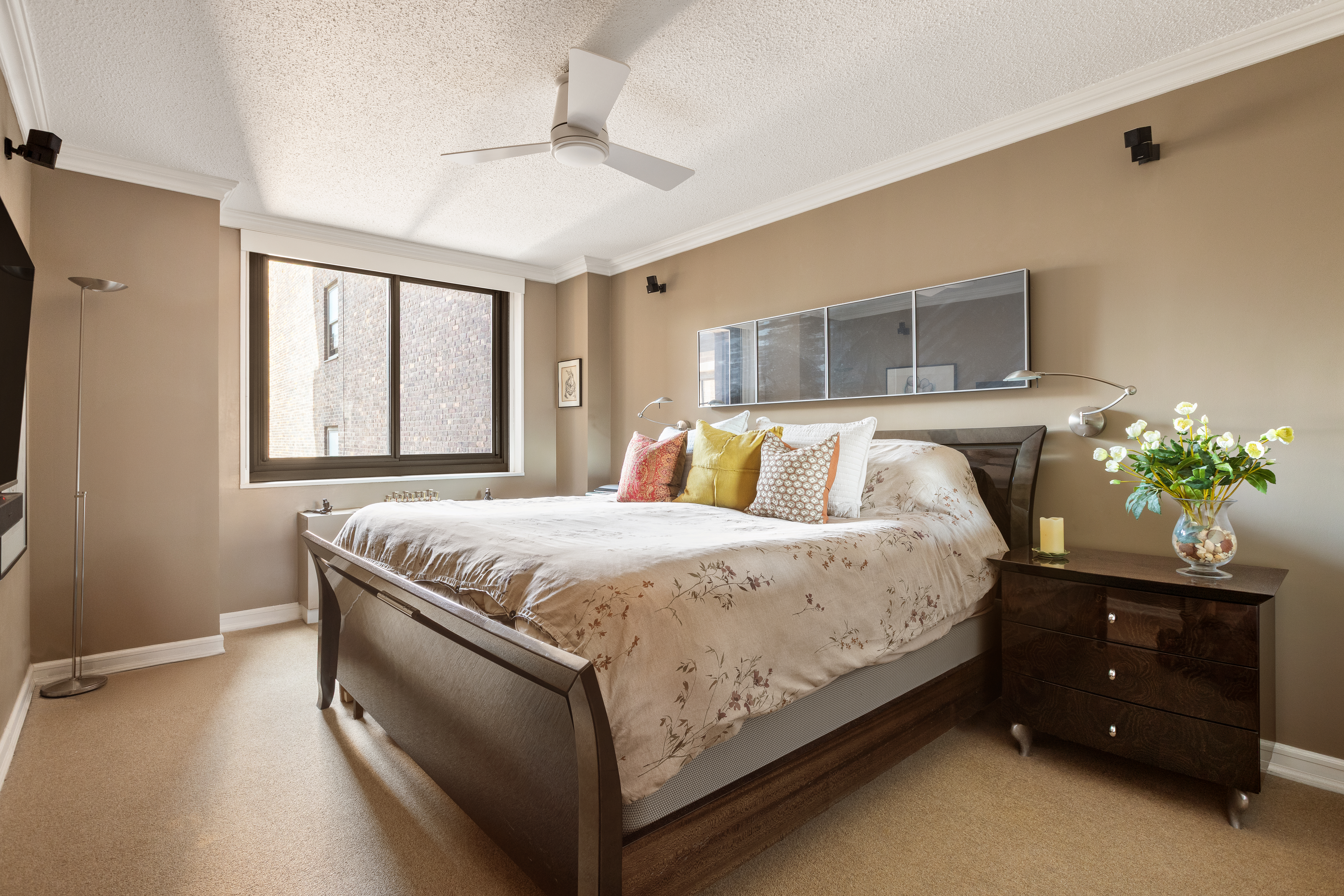 347 West 57th Street, Unit 25AB Manhattan, NY 10019 - Photo 7 of 21 a bed sitting in a spacious bedroom next to a window