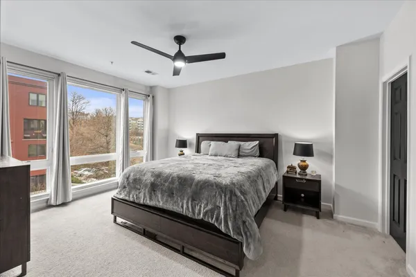 a bedroom with a large bed and a large window