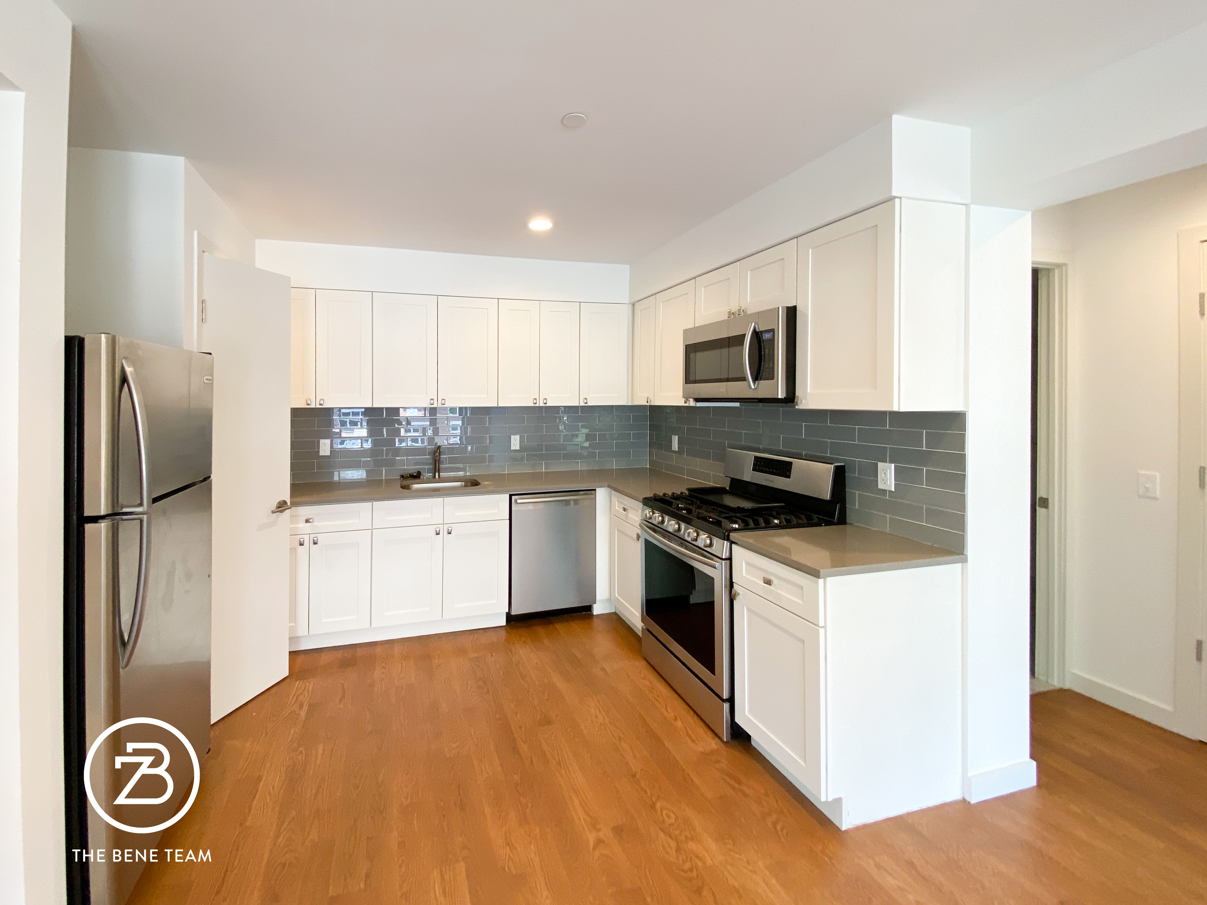 14-25 27th Avenue, Unit 3A Queens, NY 11102 - Photo 4 of 9 a kitchen with a refrigerator and a stove top oven