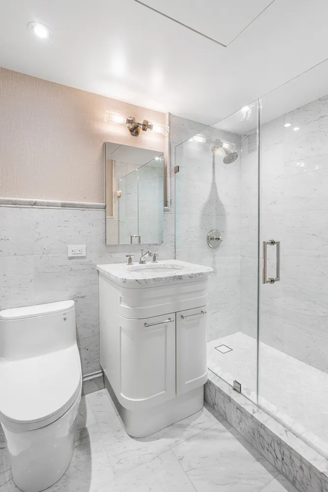 a bathroom with a sink toilet and shower