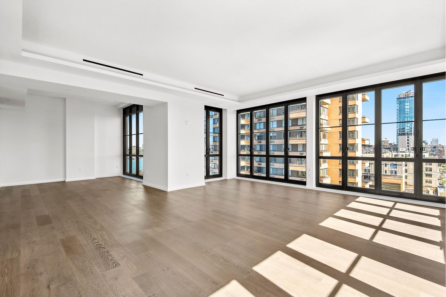 250 West 96th Street, Unit 18C Manhattan, NY 10025 - Photo 5 of 28 a view of an empty room with wooden floor and a window