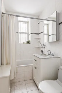 a bathroom with a sink a toilet and tub