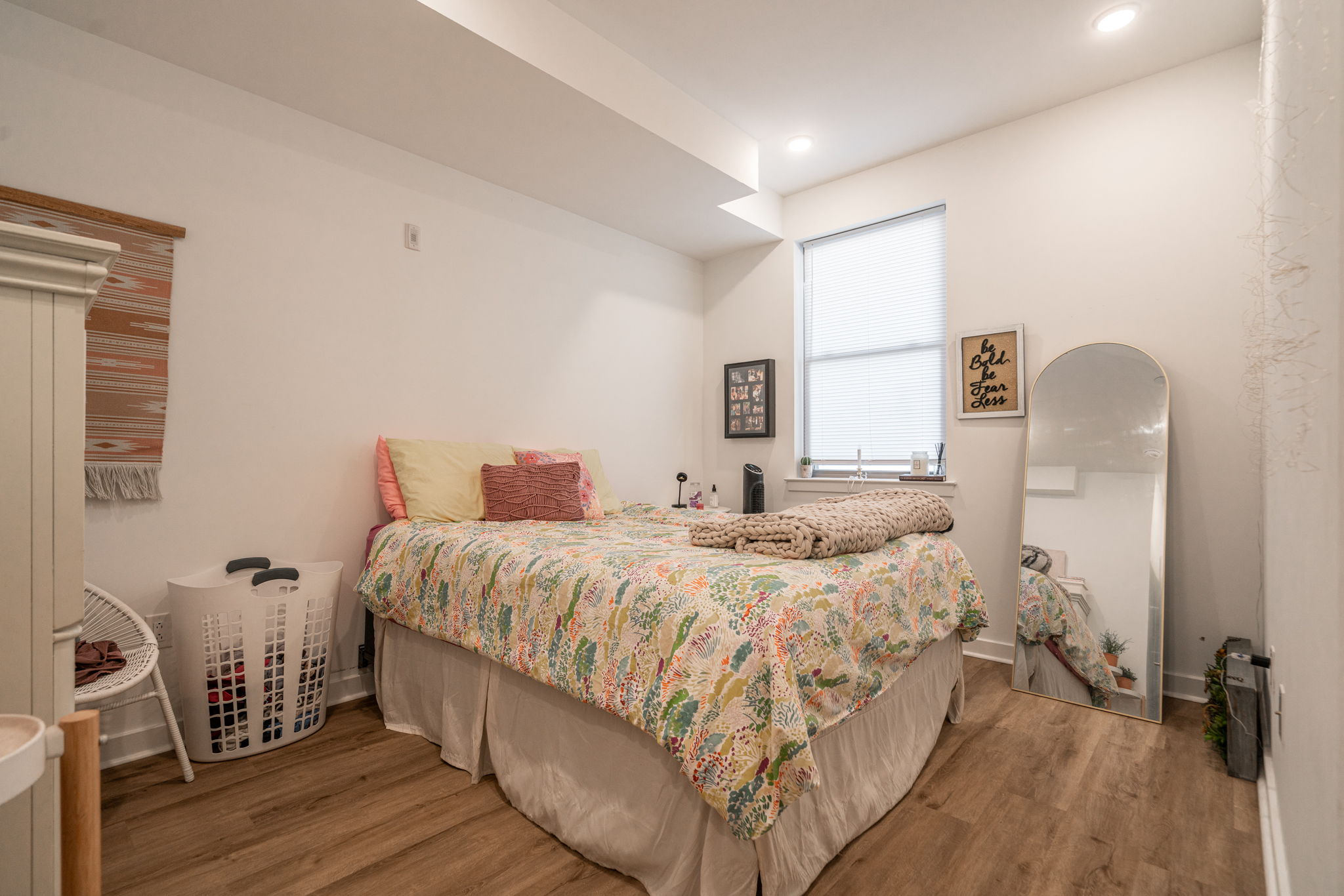 2613 Federal Street, Unit B Philadelphia, PA 19146 - Photo 10 of 21 a bedroom with a bed a mirror and a wooden floor