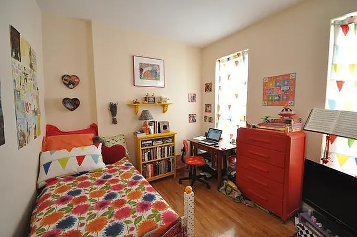 416 East 71st Street, Unit 21 Manhattan, NY 10021 - Photo 2 of 5 a bedroom with a bed and furniture