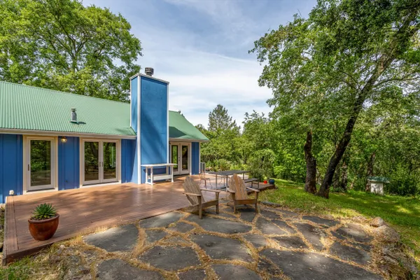 a view of backyard with swimming pool and sitting area
