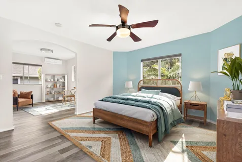 a bedroom with a bed and wooden floor
