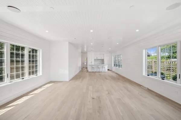 a kitchen with white cabinets and chairs