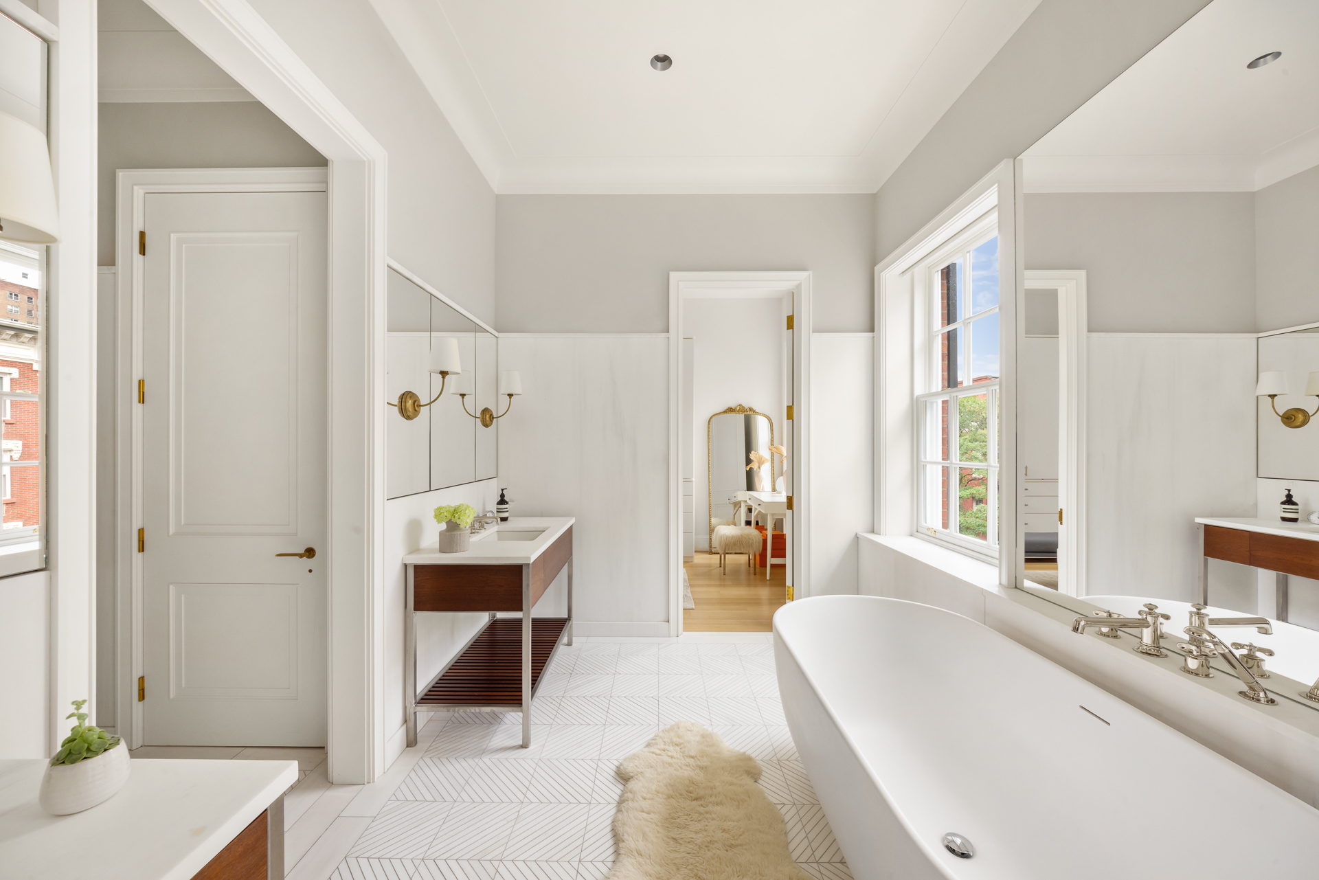 334 West 20th Street Manhattan, NY 10011 - Photo 14 of 20 a spacious bathroom with a tub sink and mirror