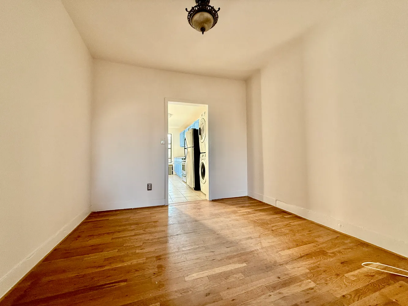 a view of an empty room and wooden floor