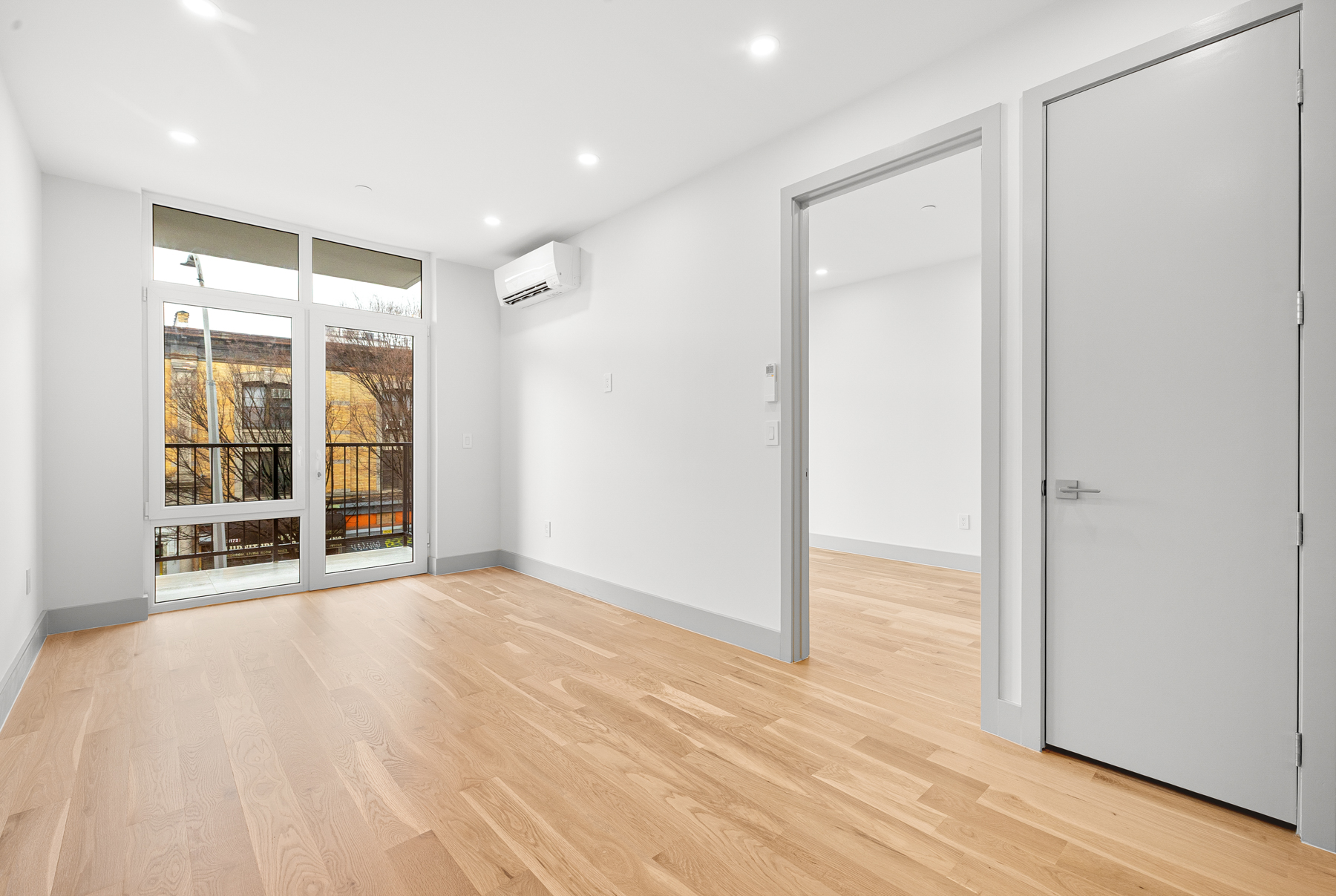 1155 Bedford Avenue, Unit 3F Brooklyn, NY 11216 - Photo 2 of 12 a view of an empty room with wooden floor and a window