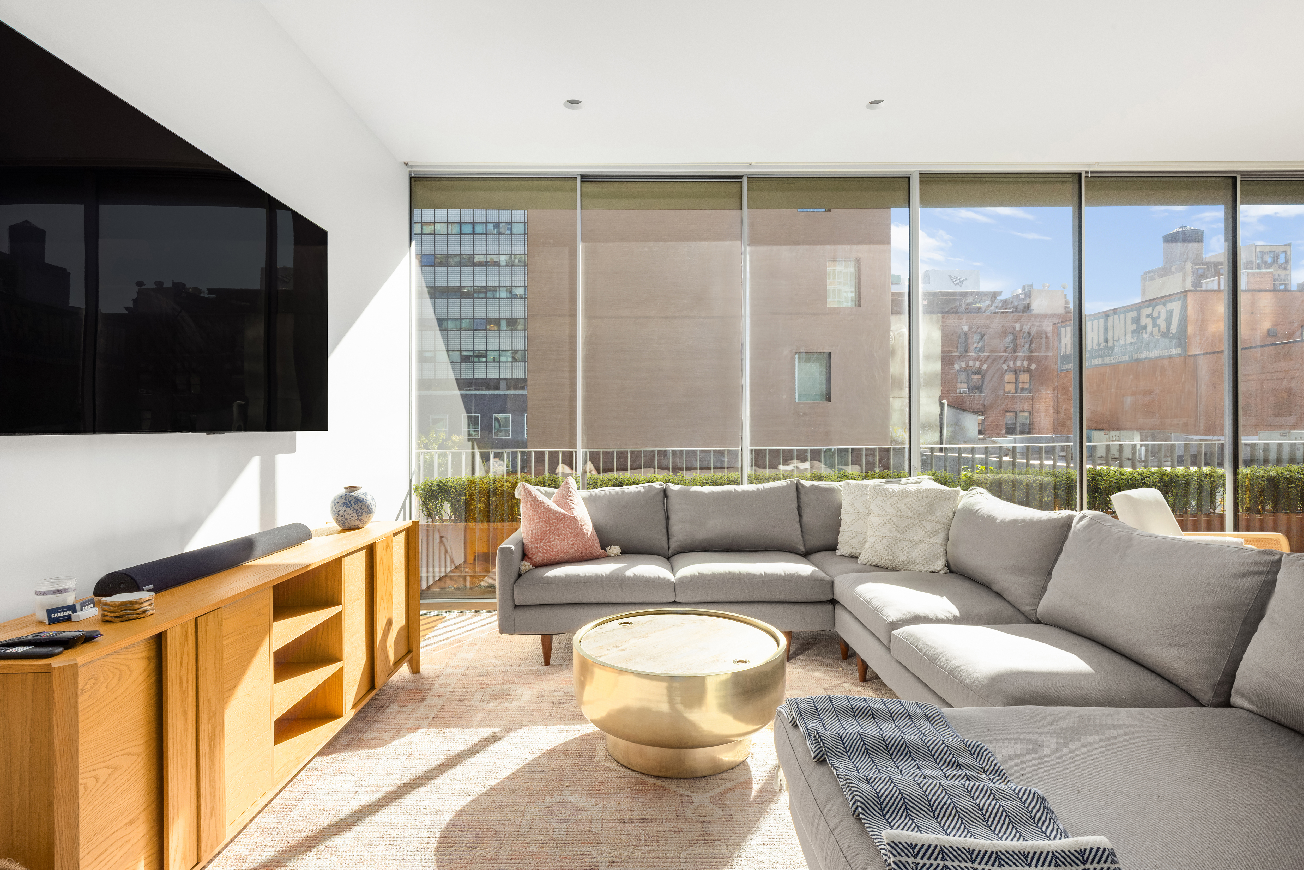 527 West 27th Street, Unit 4C Manhattan, NY 10001 - Photo 2 of 25 a living room with furniture and a flat screen tv