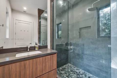 a bathroom with a double vanity sink and a mirror