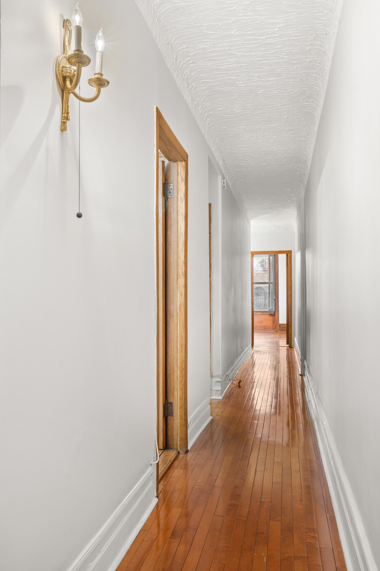 527 West 143rd Street, Unit 31 Manhattan, NY 10031 - Photo 25 of 29 a view of hallway with wooden floor