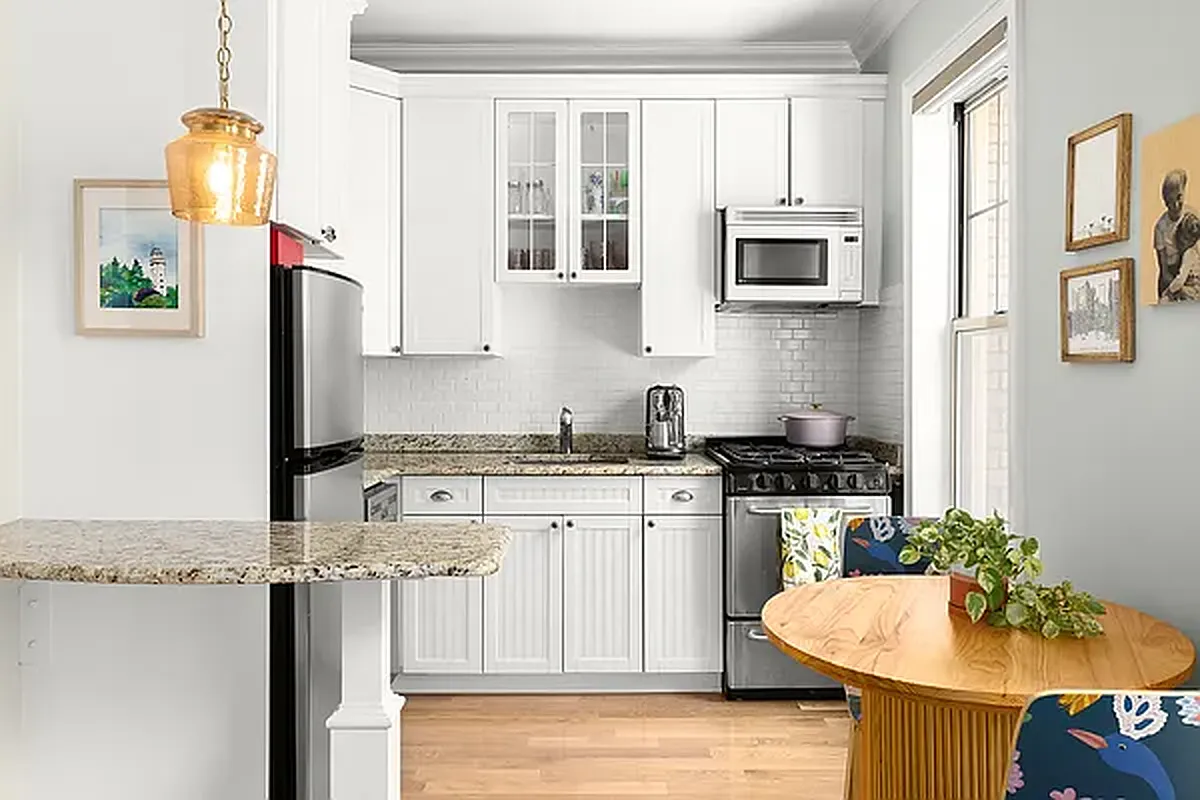 204 West 10th Street, Unit 18 Manhattan, NY 10014 - Photo 2 of 10 a kitchen with stainless steel appliances granite countertop a stove and white cabinets