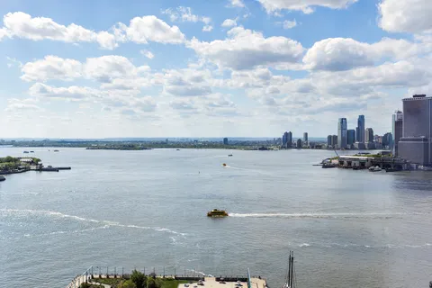 a living room with furniture and floor to ceiling windows