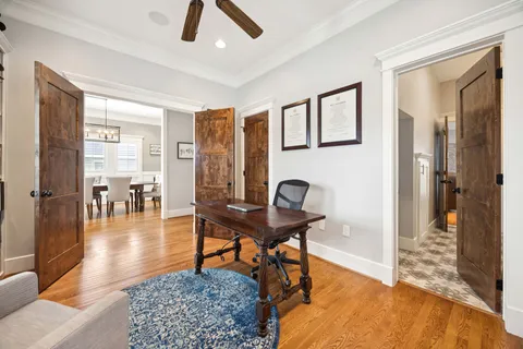 a living room with furniture a rug and a chandelier
